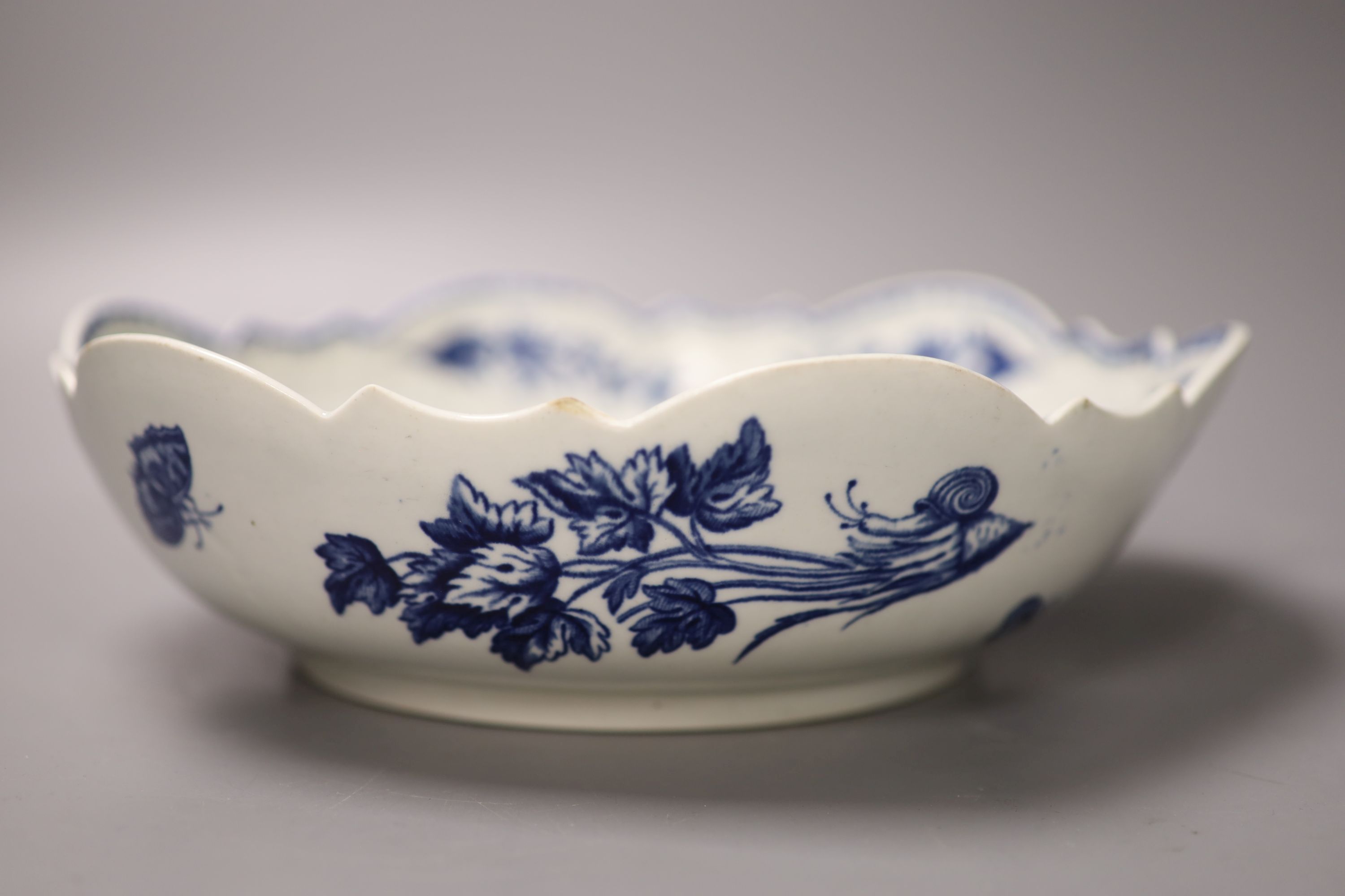 A Worcester salad bowl printed on the inside in underglaze blue with flowers, pomegranate and fir cones,